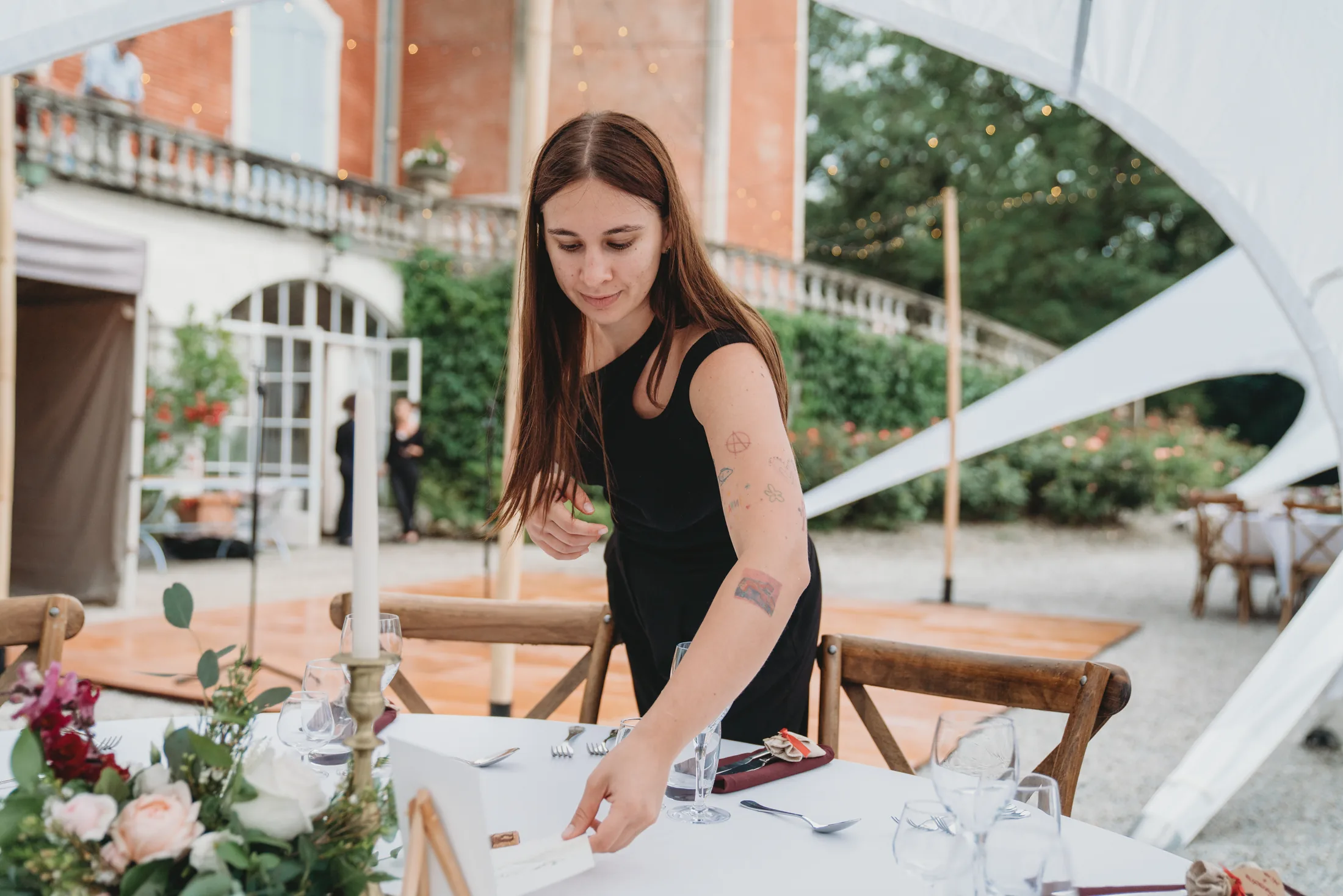 A member of the team setting a table for dinner