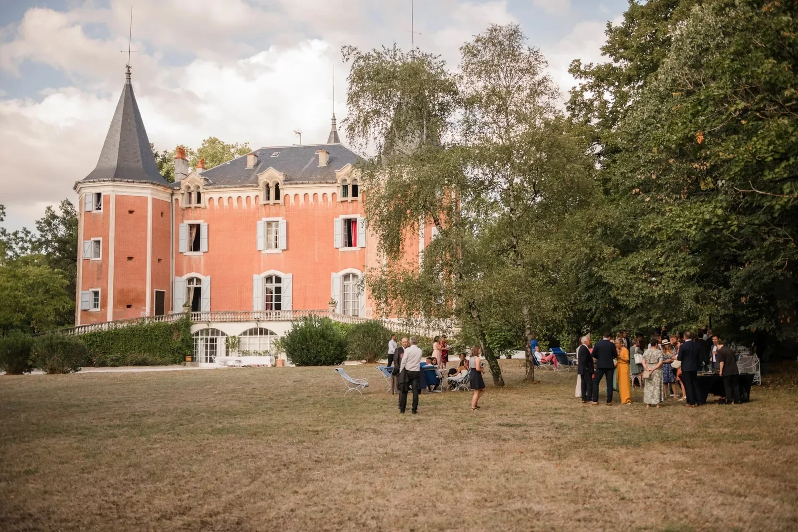 Guests in nineteenth-century costume in front of the château