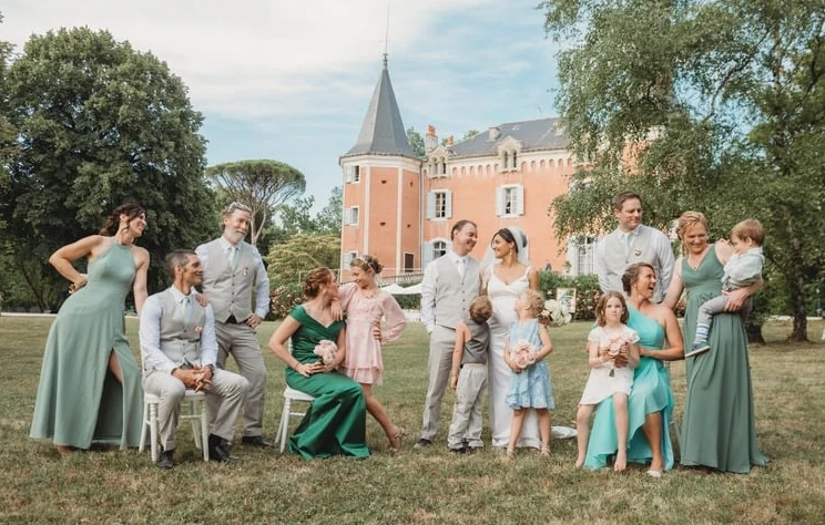 A family gathered on the lawn in front of Château de Garrevaques