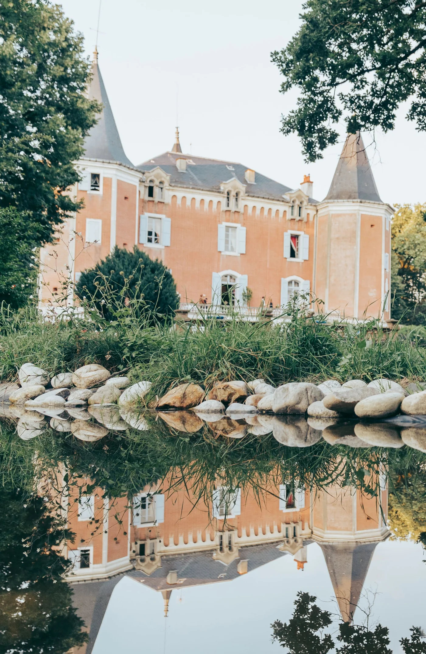 Château de Garrevaques reflected in the water of the park