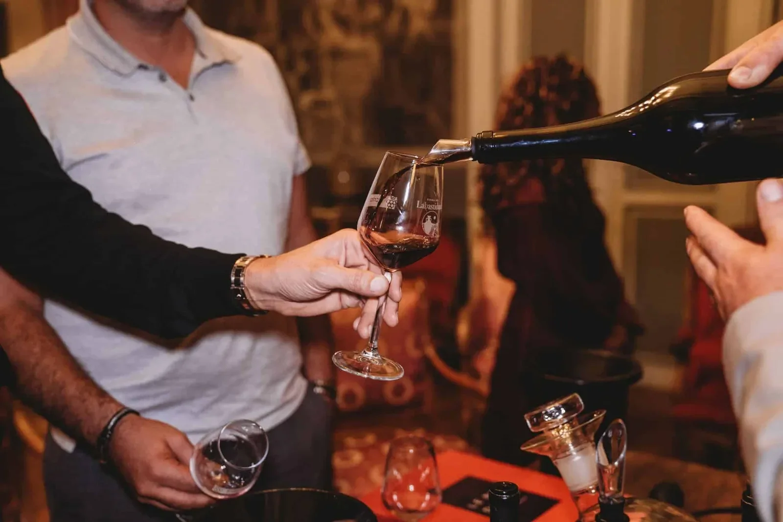 The sommelier pouring wine