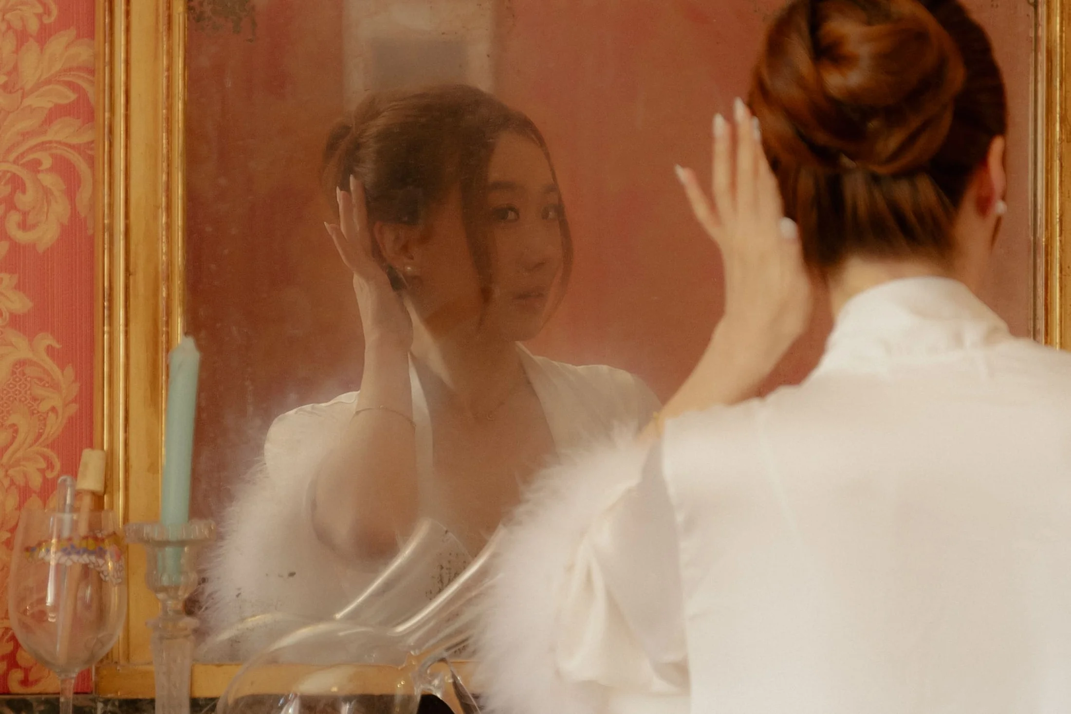 The bride getting ready in front of the mirror